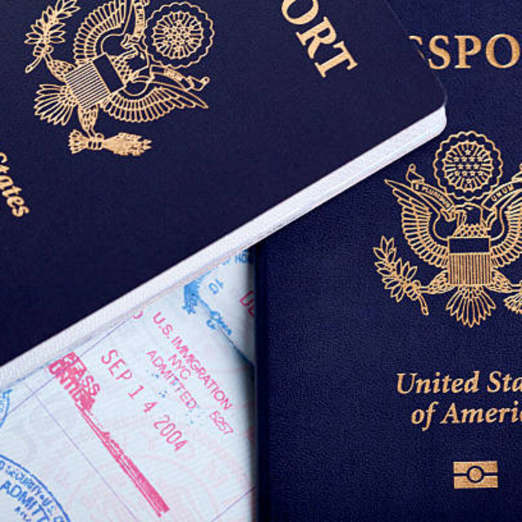 American passports and immigration stamps on an open passport page.